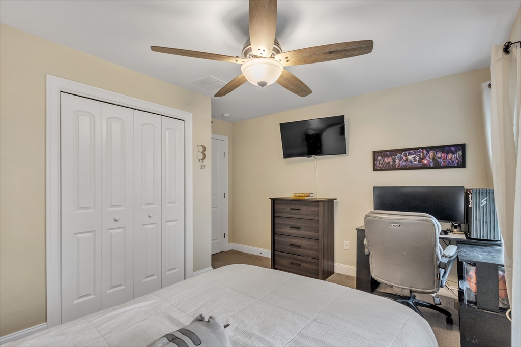 24 Old County Road Ashburnham, MA 01430 - Photo 20 of 32 a bedroom with a bed and a flat screen tv