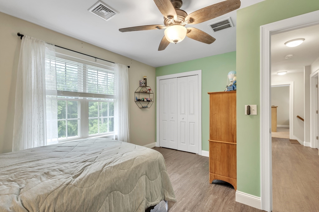 24 Old County Road Ashburnham, MA 01430 - Photo 22 of 32 a bedroom with a large bed a chandelier and a window