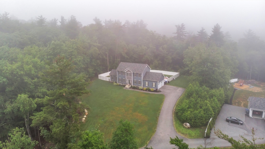24 Old County Road Ashburnham, MA 01430 - Photo 31 of 32 an aerial view of a house with yard and trees in the background