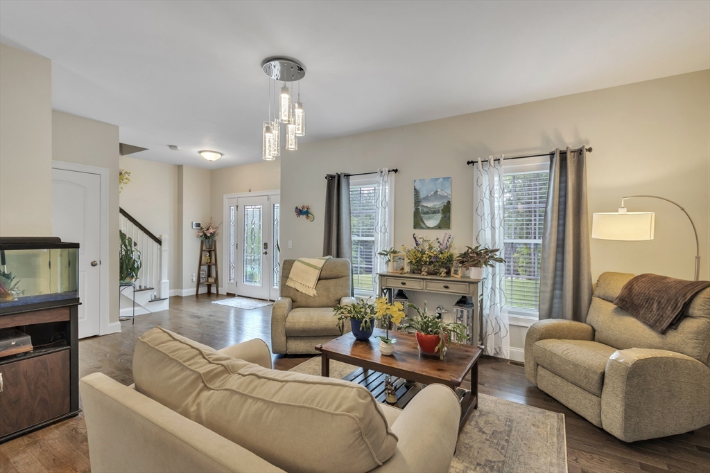 24 Old County Road Ashburnham, MA 01430 - Photo 7 of 32 a living room with furniture and a chandelier