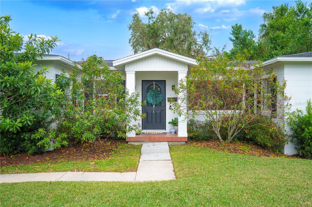 516 Sagamore Street Lakeland, FL 33803 - Photo 1 of 1 a view of a house with brick walls and a yard with plants and large trees