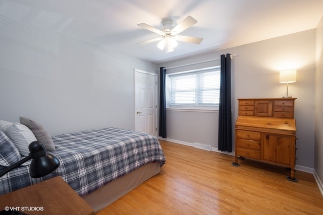 546 North Rohlwing Road Palatine, IL 60074 - Photo 12 of 17 a bedroom with a bed and a ceiling fan