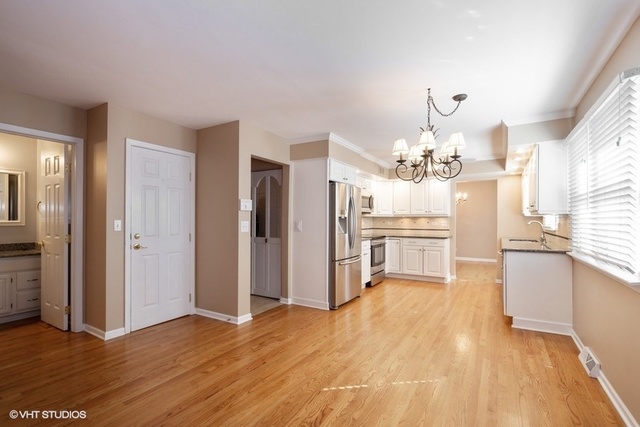 546 North Rohlwing Road Palatine, IL 60074 - Photo 4 of 17 a view of a kitchen with a sink dishwasher a kitchen view and a refrigerator
