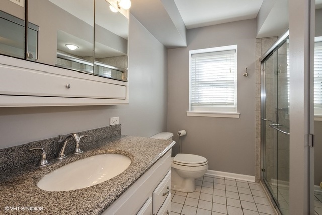 546 North Rohlwing Road Palatine, IL 60074 - Photo 8 of 17 a bathroom with a granite countertop sink and a mirror