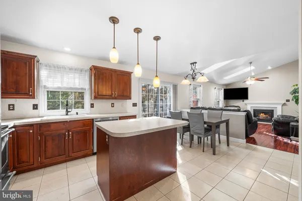 a large kitchen with lots of counter space and dining table