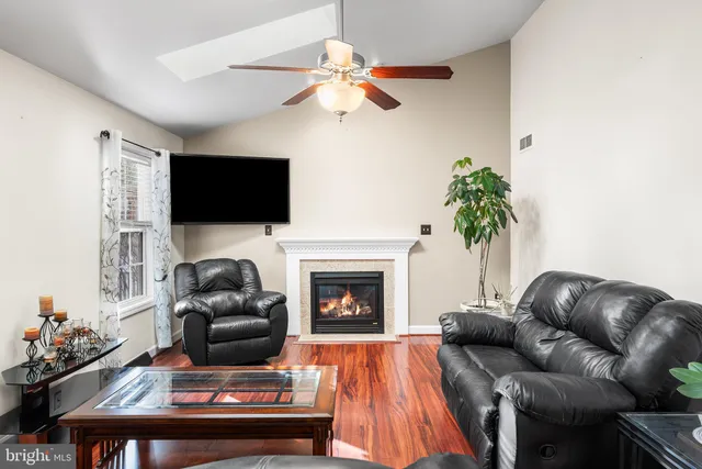 a living room with furniture a fireplace and a flat screen tv