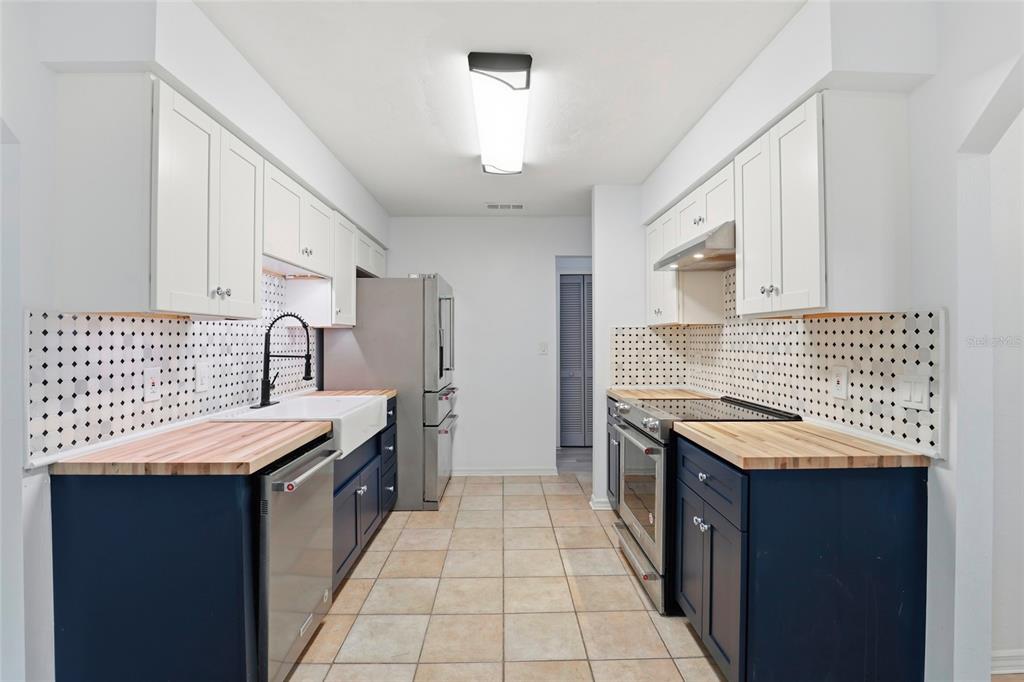 10808 Northwest 31st Place Gainesville, FL 32606 - Photo 14 of 38 a kitchen with granite countertop a sink stove and cabinets