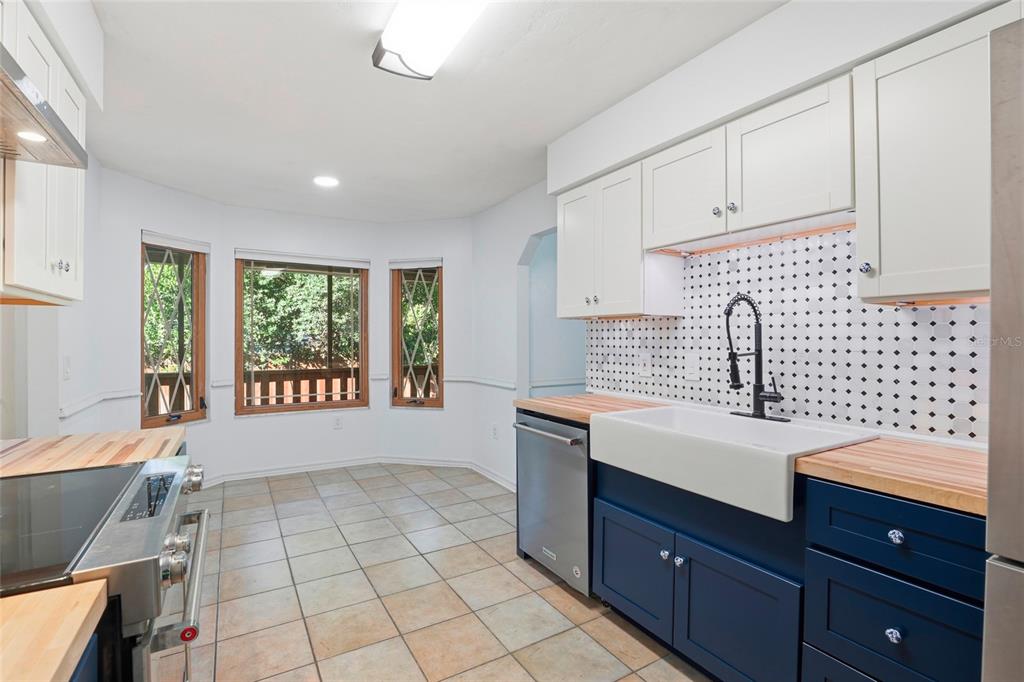10808 Northwest 31st Place Gainesville, FL 32606 - Photo 15 of 38 a kitchen with a sink window and cabinets
