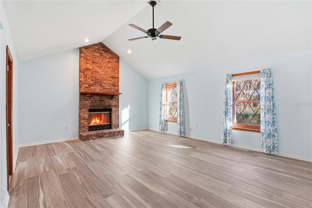 10808 Northwest 31st Place Gainesville, FL 32606 - Photo 6 of 38 a view of empty room with wooden floor and fan
