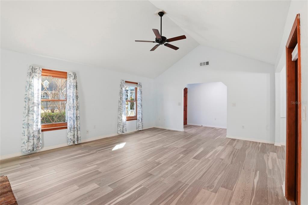10808 Northwest 31st Place Gainesville, FL 32606 - Photo 7 of 38 a view of empty room with wooden floor and fan