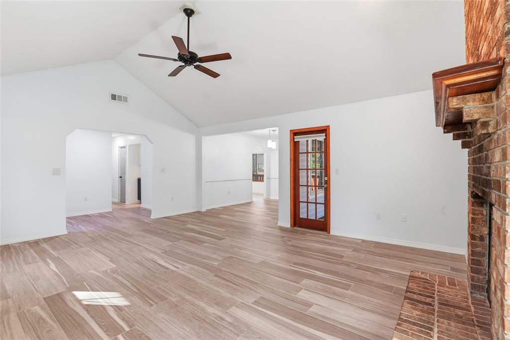 10808 Northwest 31st Place Gainesville, FL 32606 - Photo 8 of 38 a view of a room with a ceiling fan wooden floor and ceiling fan