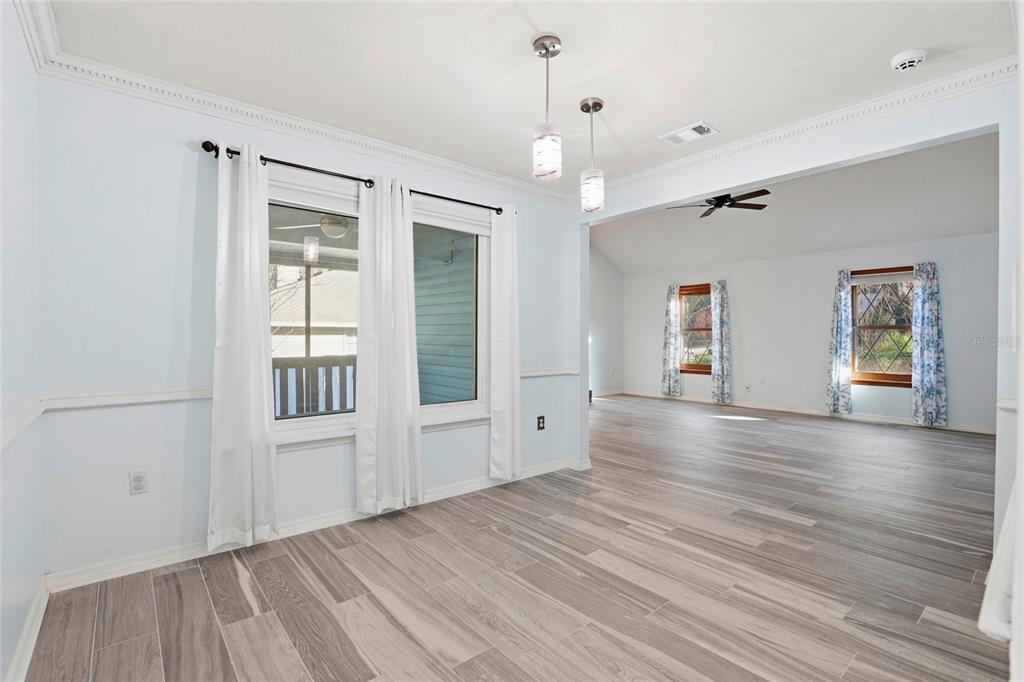 10808 Northwest 31st Place Gainesville, FL 32606 - Photo 10 of 38 a view of an empty room with a window and wooden floor