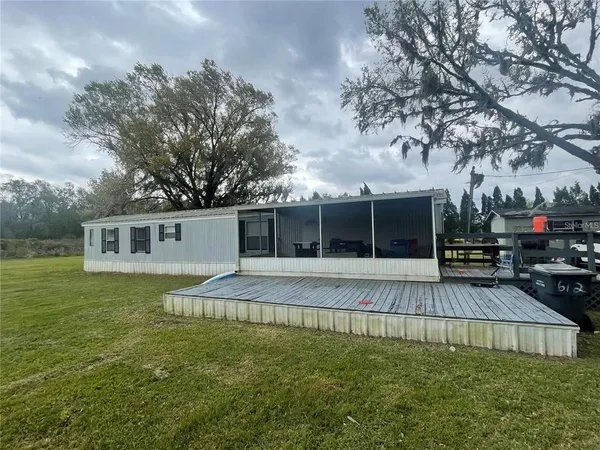 a backyard of a house with table and chairs