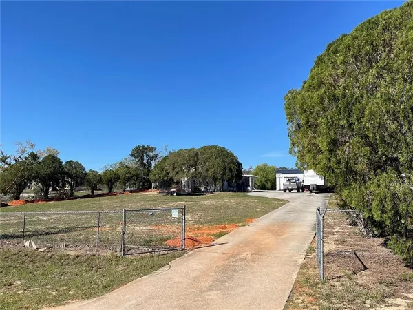 a white house with a yard and sitting area