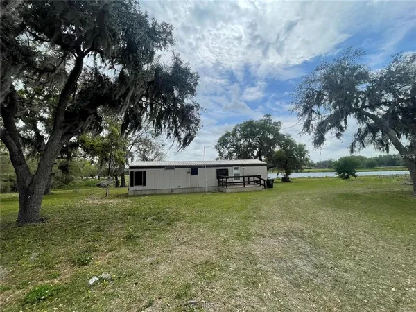 a view of a house with a backyard