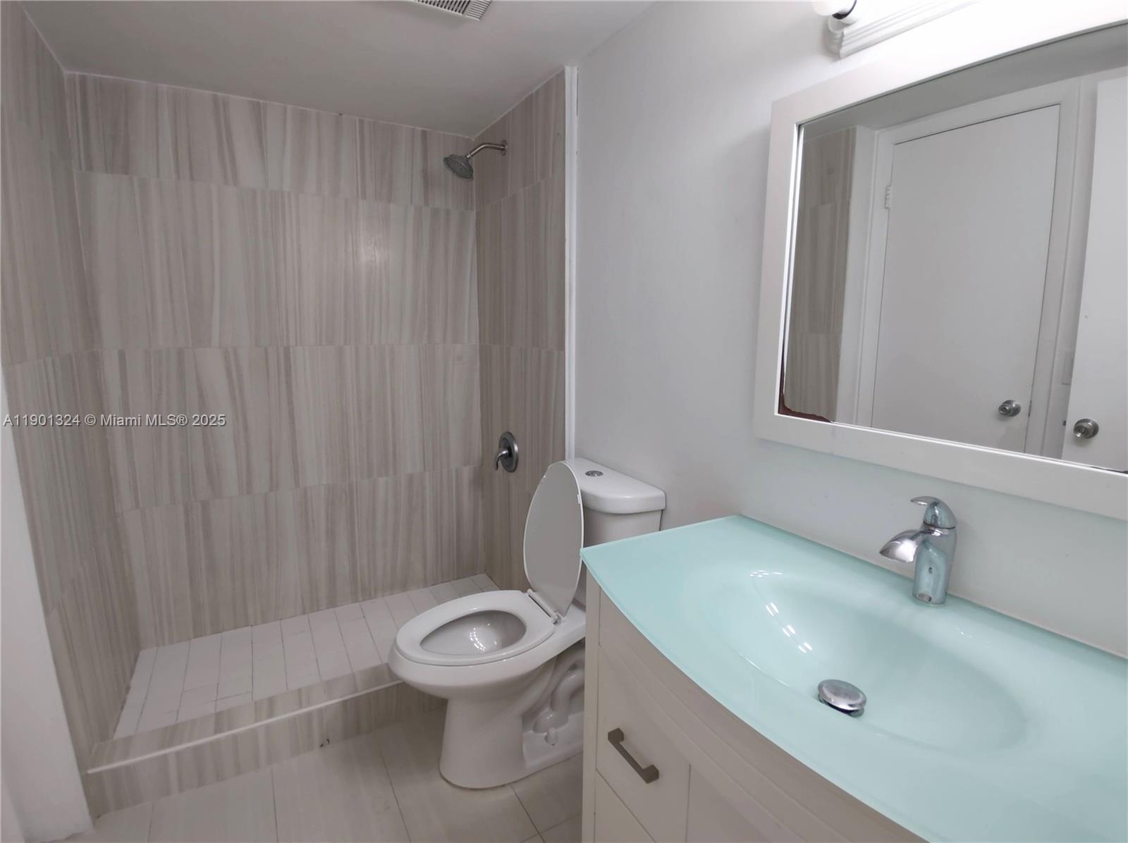 15500 Southwest 80th Street, Unit A105 Miami, FL 33193 - Photo 14 of 36 a bathroom with a sink a toilet and shower