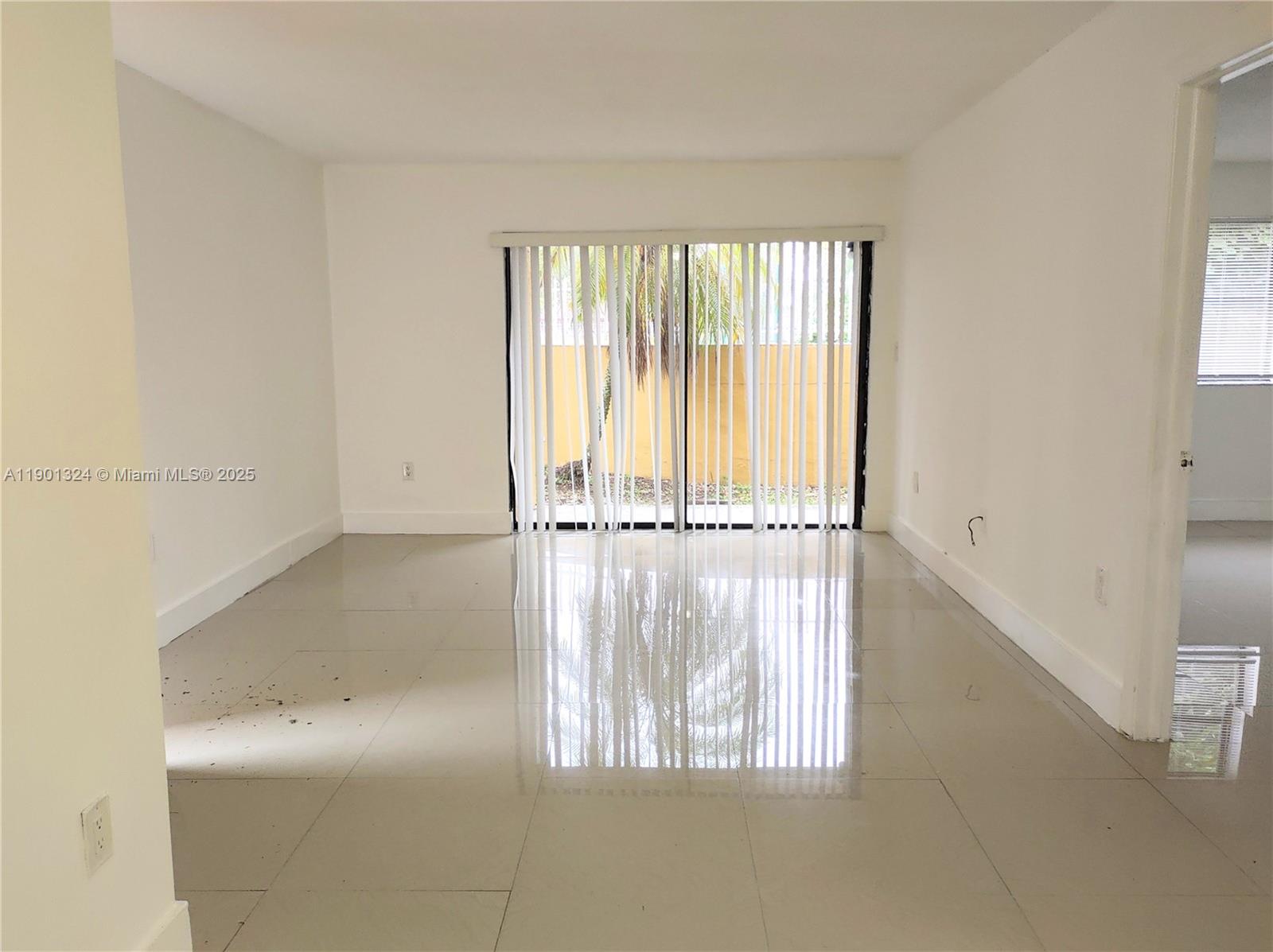 15500 Southwest 80th Street, Unit A105 Miami, FL 33193 - Photo 29 of 36 a view of an empty room with a window