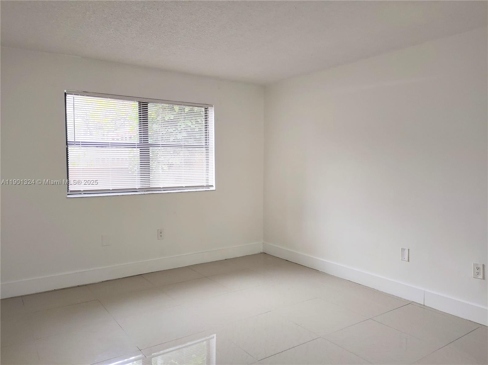 15500 Southwest 80th Street, Unit A105 Miami, FL 33193 - Photo 31 of 36 an empty room with a window