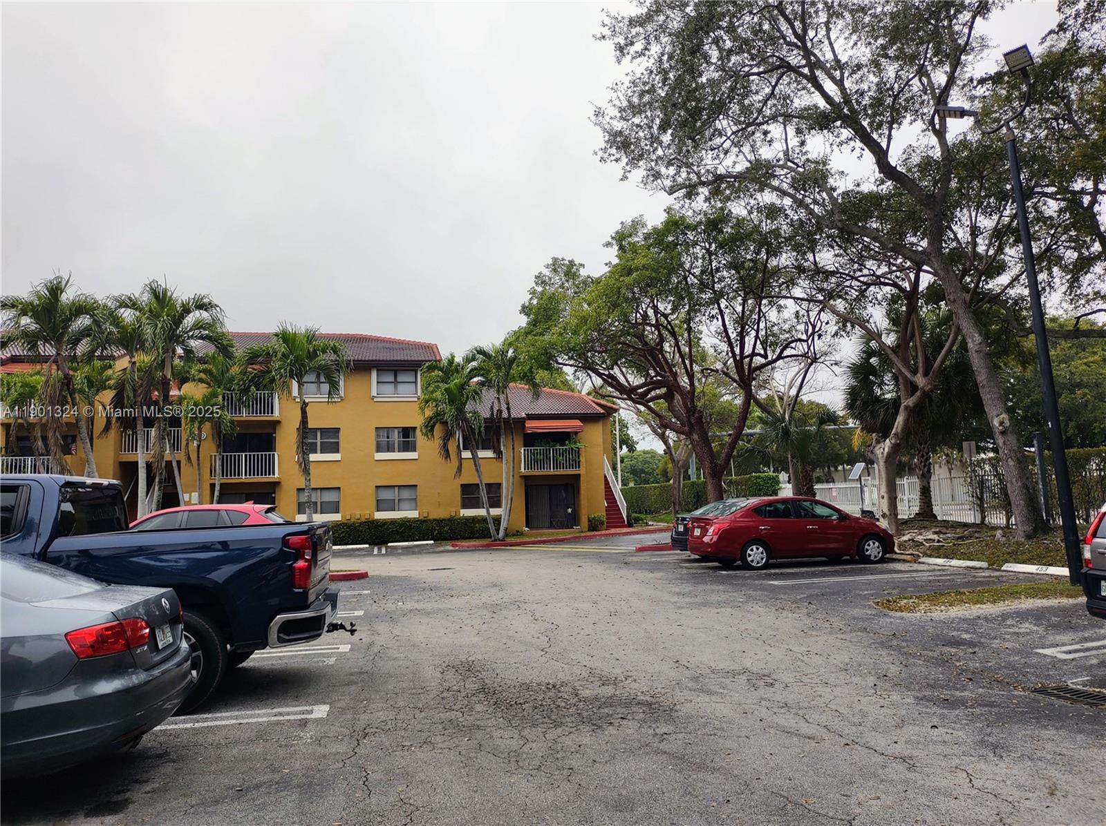 15500 Southwest 80th Street, Unit A105 Miami, FL 33193 - Photo 33 of 36 a parked cars parked in front of a house