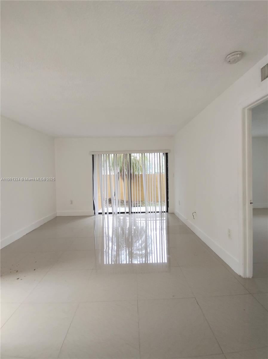 15500 Southwest 80th Street, Unit A105 Miami, FL 33193 - Photo 10 of 36 an empty room with window