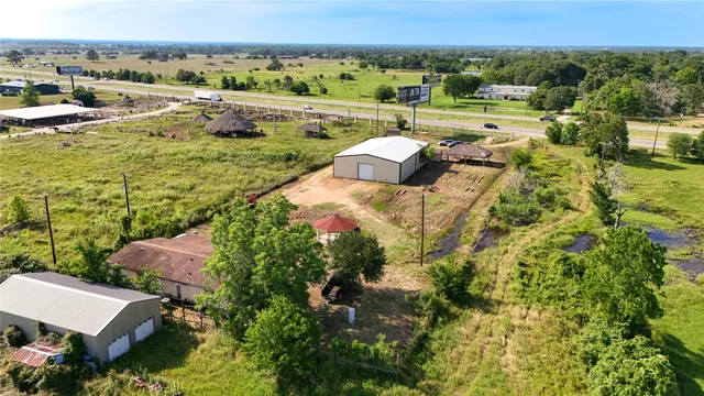 a front view of house with yard and trees in the background
