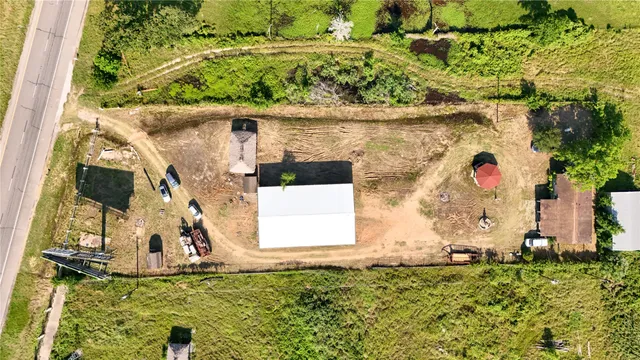an aerial view of a house with a yard