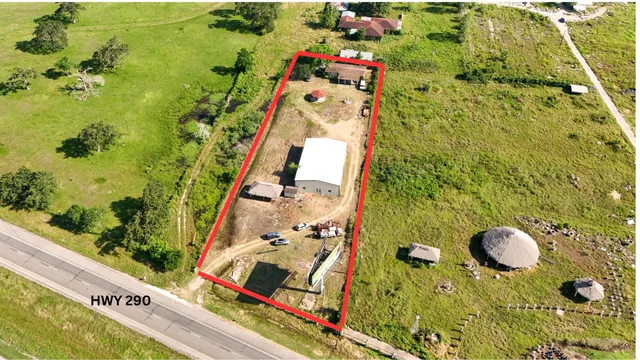 an aerial view of residential houses with outdoor space and swimming pool