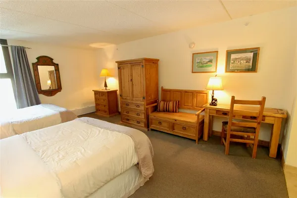 a bedroom with bed and a chandelier