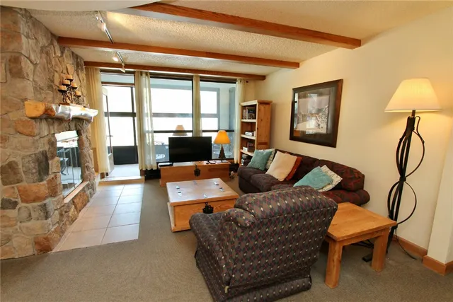 a living room with furniture and a floor to ceiling window