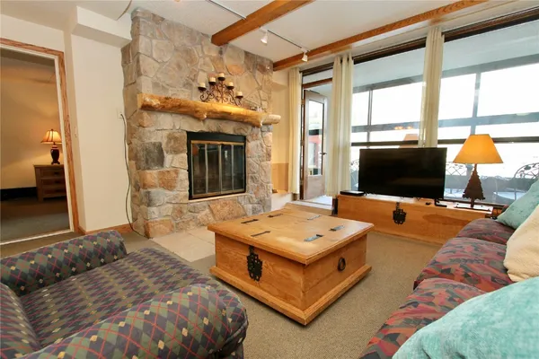 a spacious bedroom with a bed and a flat screen tv