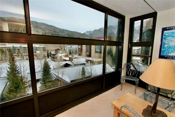 a view of a city from a balcony with furniture