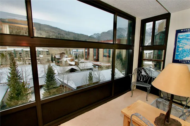 a view of a city from a balcony with furniture
