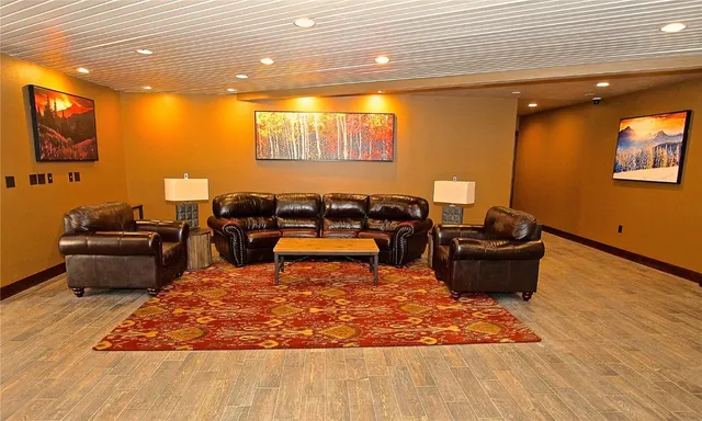 a living room with furniture rug and wooden floor
