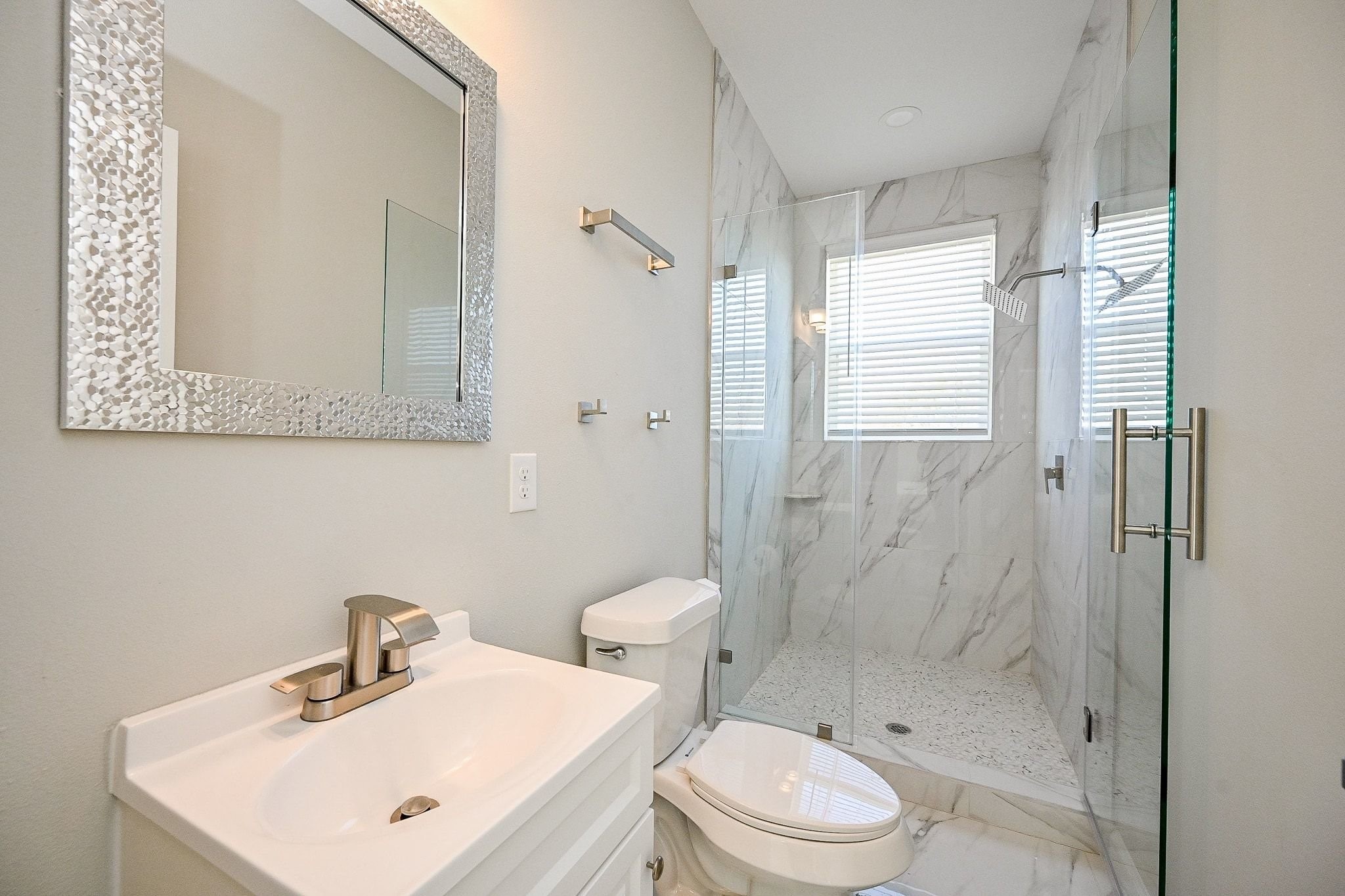 4746 Mallow Street Houston, TX 77033 - Photo 17 of 38 Secondary bathroom with stylish tile surround in shower.