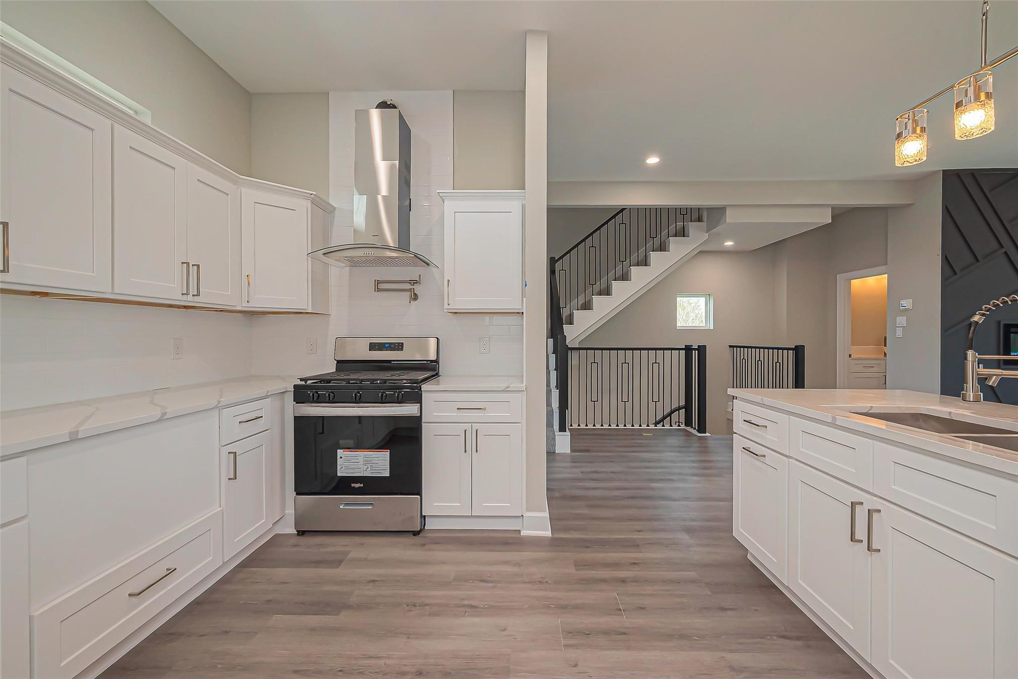 4746 Mallow Street Houston, TX 77033 - Photo 27 of 38 Unit 2: Open kitchen with modern glass and stainless venthood.