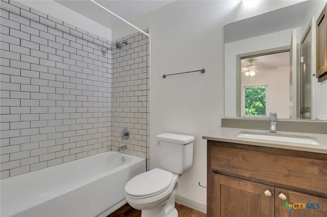 a bathroom with a sink a toilet and bathtub