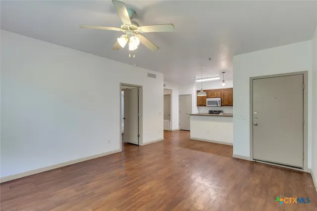 a view of a kitchen with a sink and a window