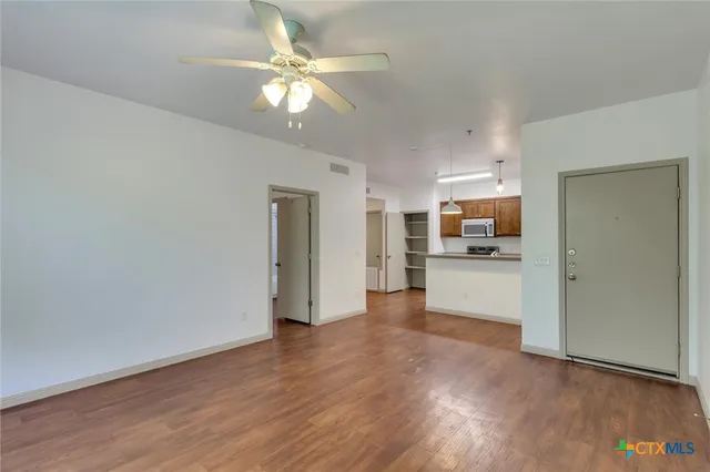 a view of a kitchen with a sink and a window