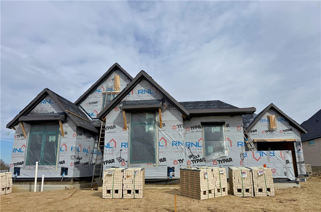 7032 Skipping Rock Path Bryan, TX 77808 - Photo 2 of 14 a front view of a house with garage
