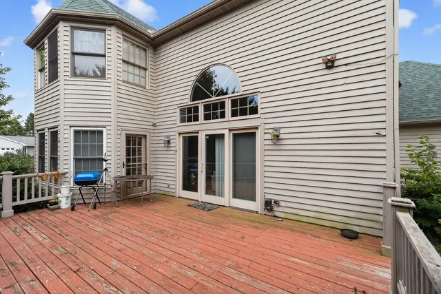 a view of a house with wooden deck