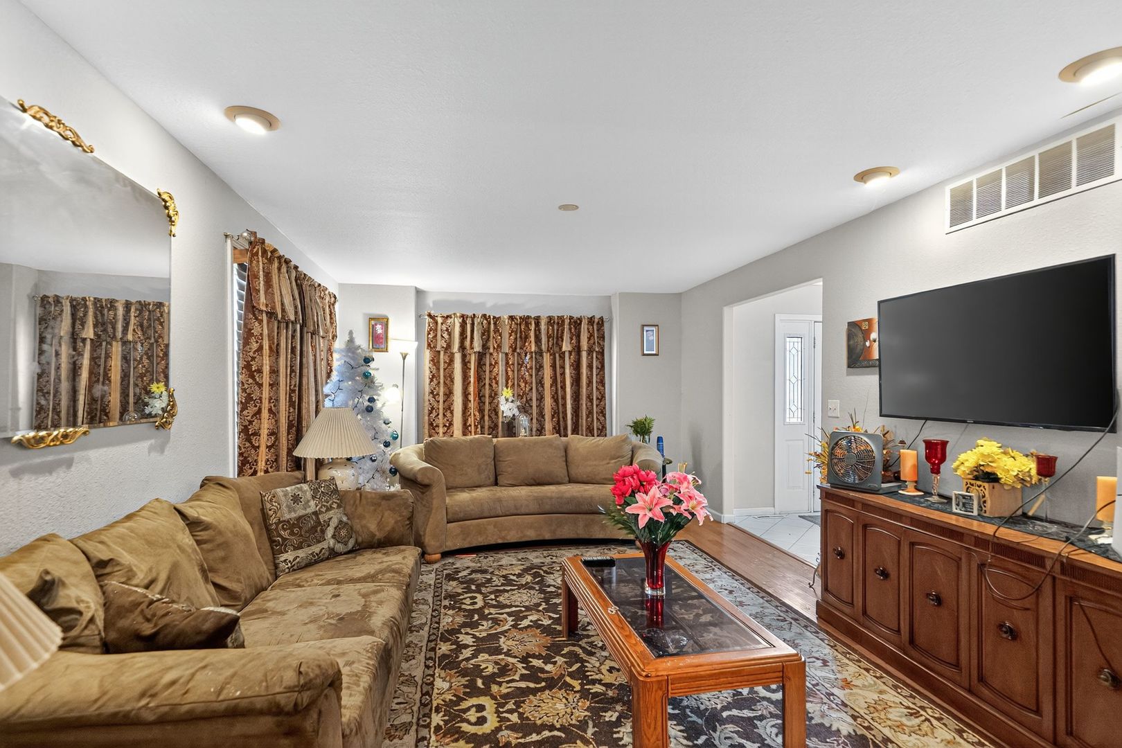 302 Jay Street Savoy, IL 61874 - Photo 4 of 16 a living room with furniture and a flat screen tv