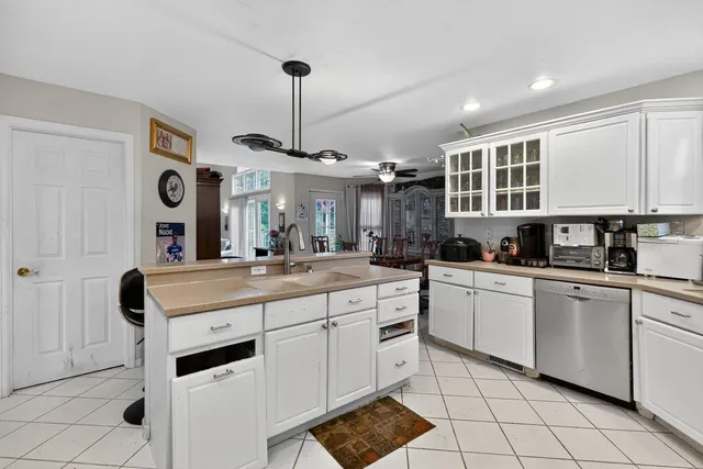 a kitchen with stainless steel appliances granite countertop a sink a stove and a refrigerator