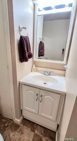 a bedroom with a bed a flat screen tv and dresser