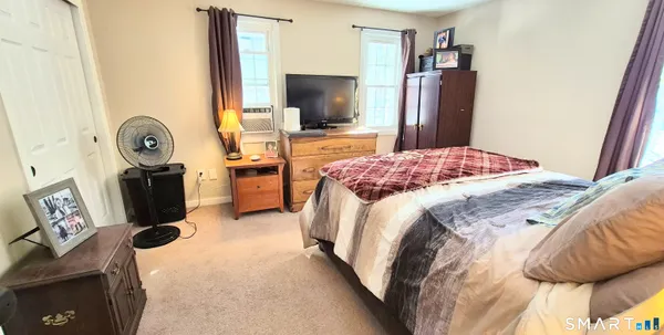 a view of a livingroom with furniture and a hallway
