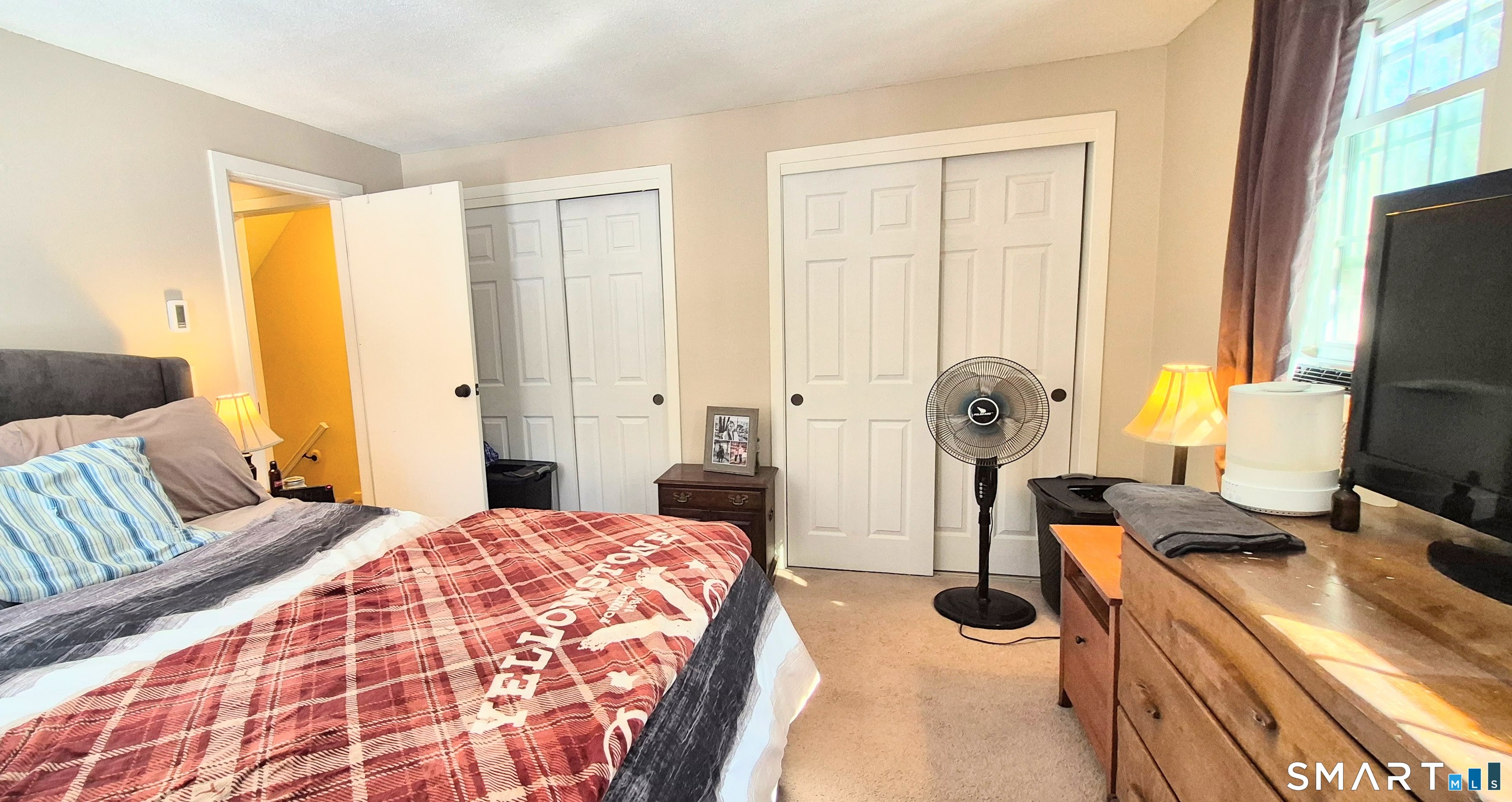 239 Old Farms Road, Unit 15C Avon, CT 06001 - Photo 21 of 29 a bedroom with a bed and large windows