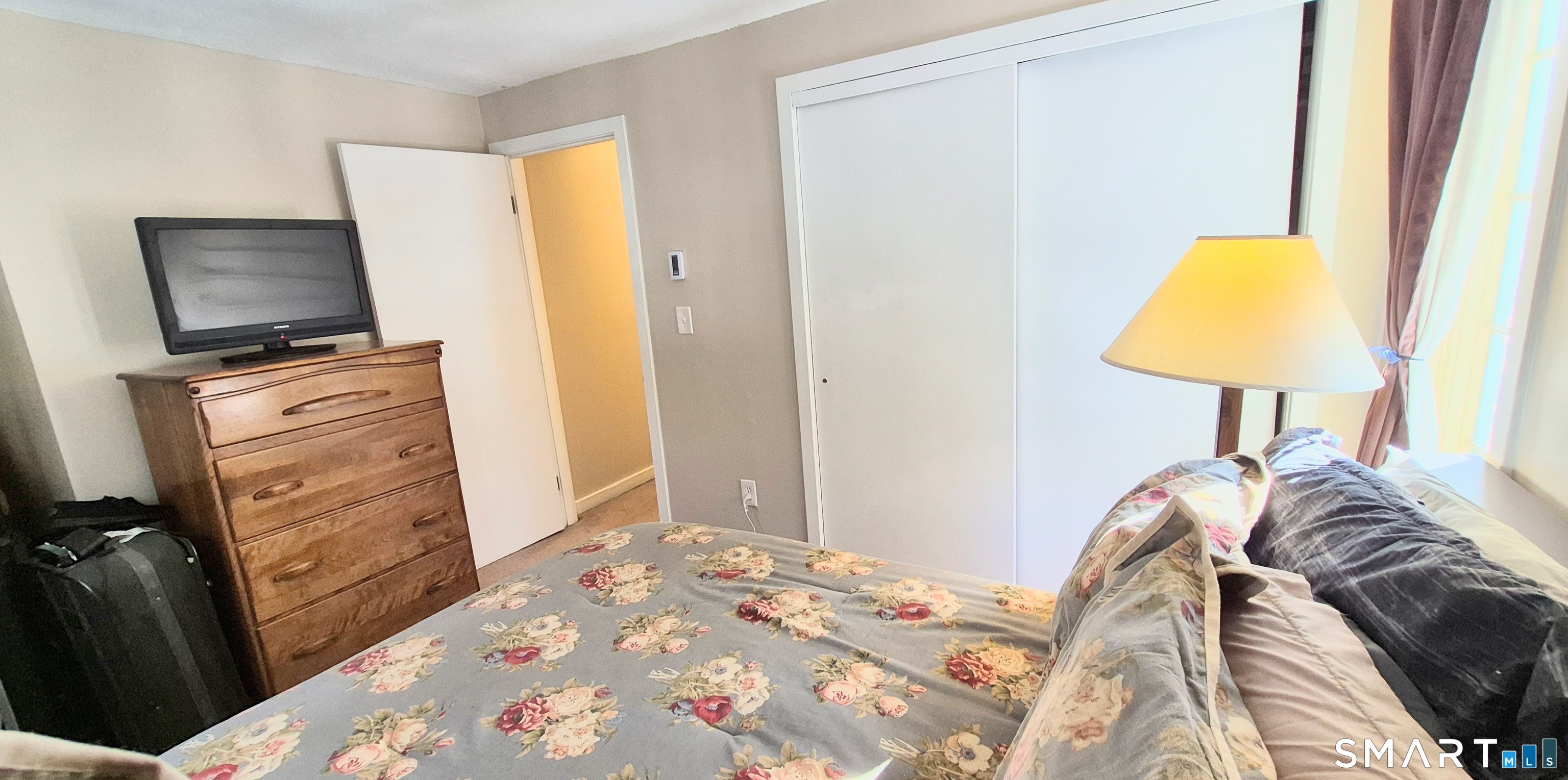 239 Old Farms Road, Unit 15C Avon, CT 06001 - Photo 25 of 29 a bedroom with a bed and a lamp