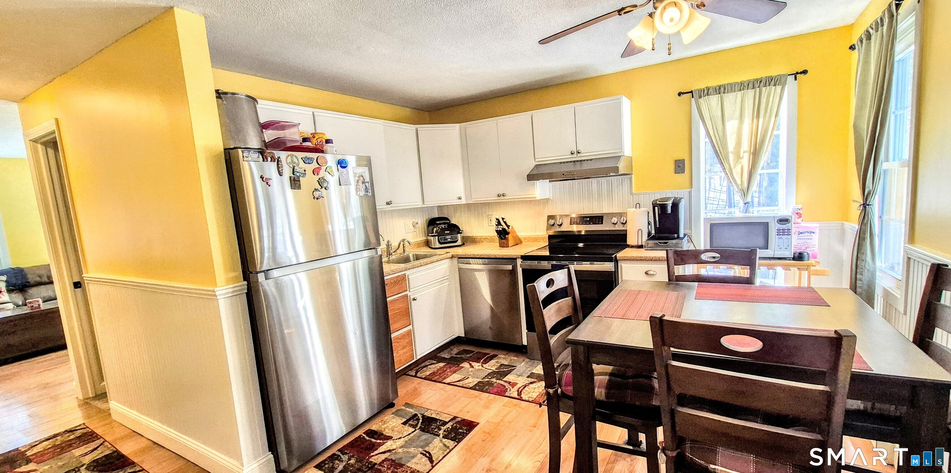 239 Old Farms Road, Unit 15C Avon, CT 06001 - Photo 6 of 29 a very nice looking room with a large window a dining table and chairs