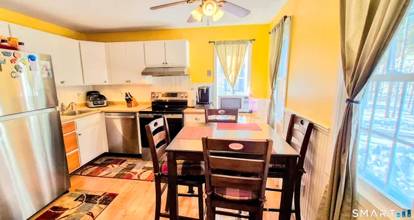 a view of a dining table and chairs in the balcony