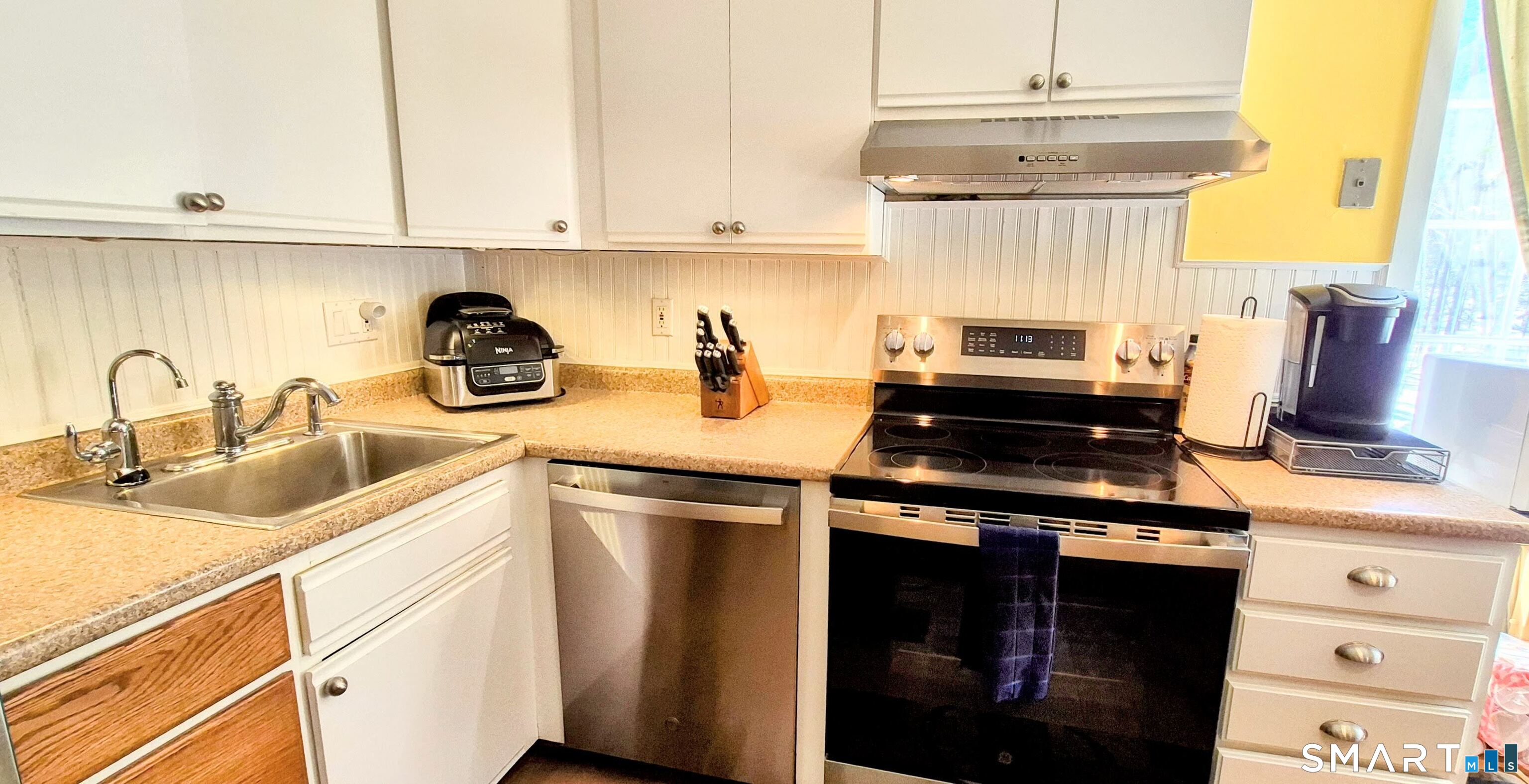 239 Old Farms Road, Unit 15C Avon, CT 06001 - Photo 8 of 29 a kitchen with a sink and cabinets