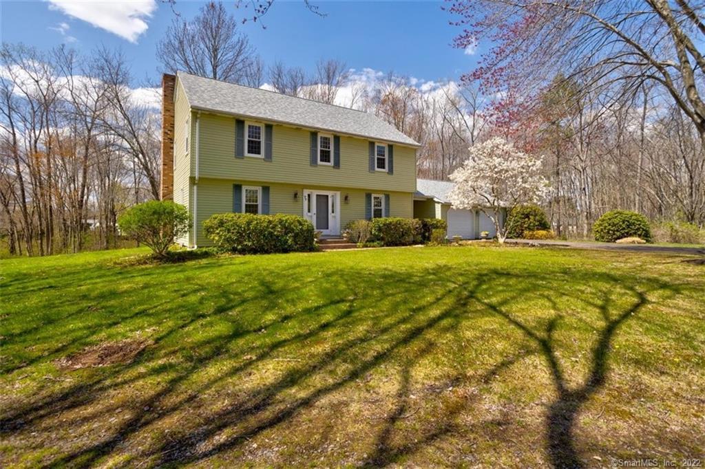 Front view of this awesome 3 bedroom, 2 1/2 bath colonial at the end of a quiet cul-de-sac set on 3+ acres with a pond.